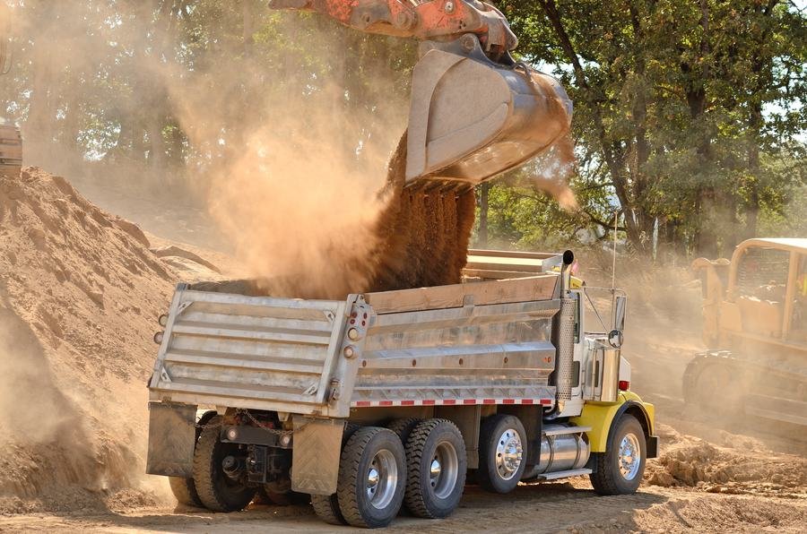 Excavator loading aggregate for hauling