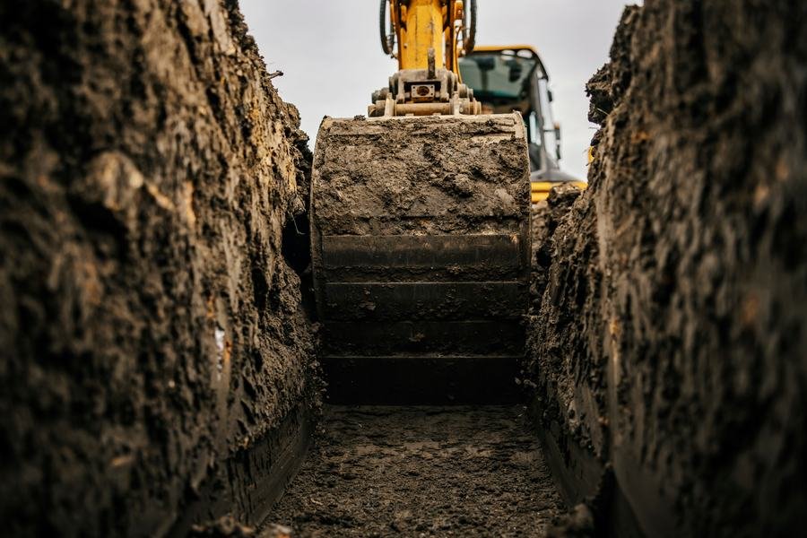 Excavator working a trench