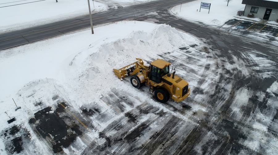 Loader clearing a commercial lot