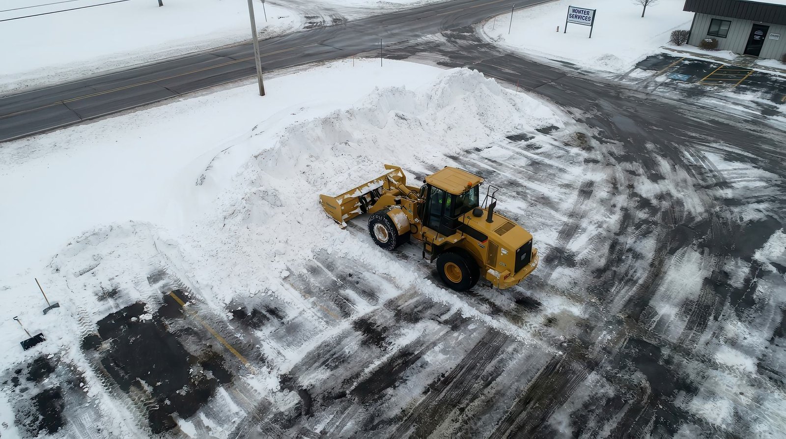 Loader clearing a commercial lot